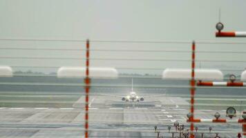 Passenger unrecognizable aircraft set speed to take off, front view long shot. Airliner on the runway. Tourism and travel concept video