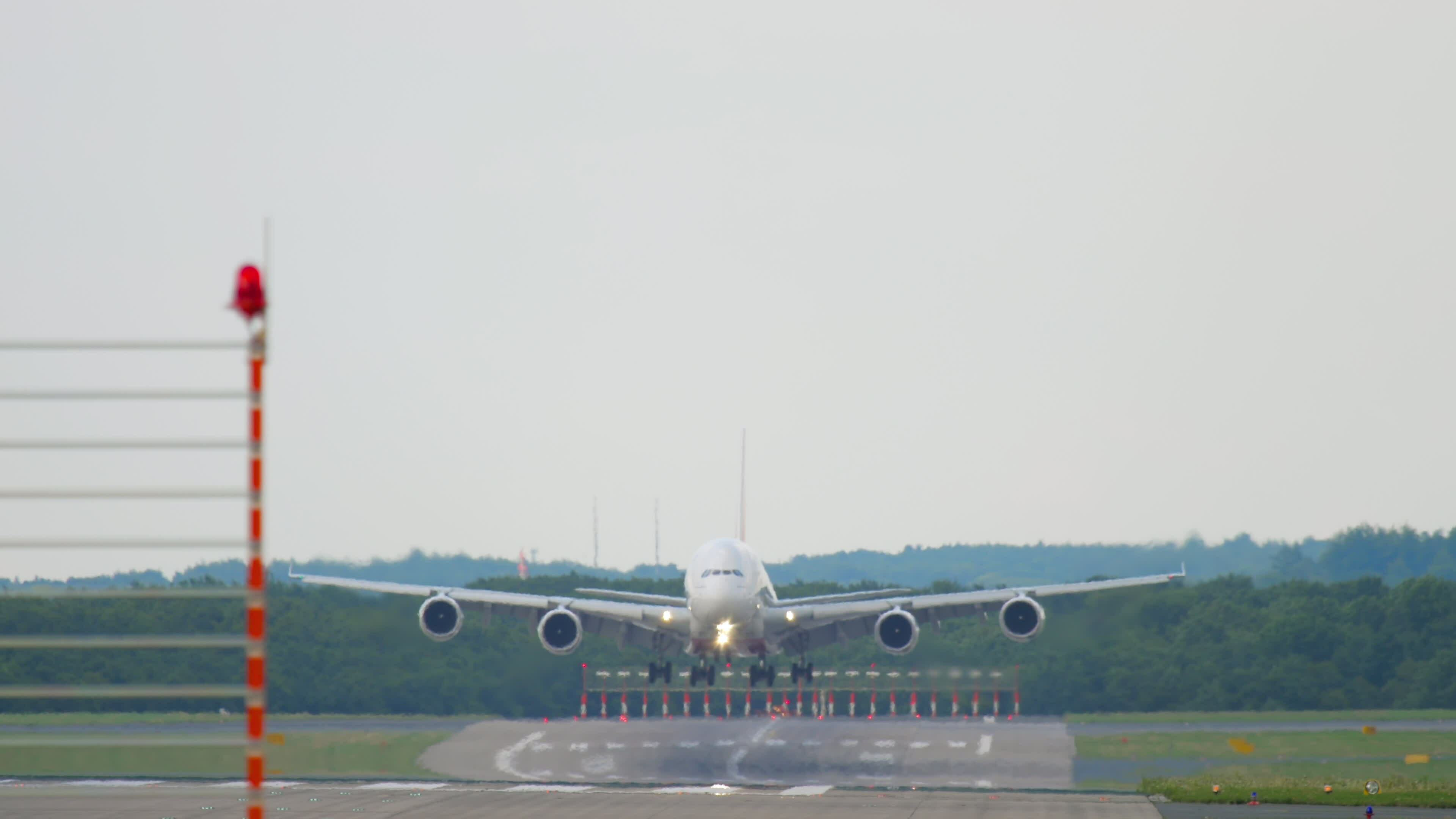 widebody-aircraft-landing-touchdown-and-braking-front-view-cinematic