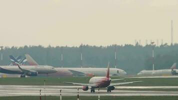 MOSCOW, RUSSIAN FEDERATION JULY 29, 2021 - Sukhoi Superjet 100 of Rossiya taxiing at Sheremetyevo airport SVO. Airport runway. Airfield traffic video