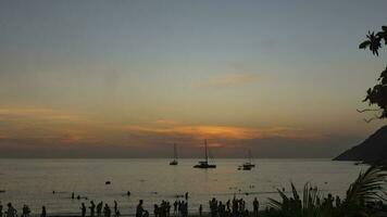 Timelapse, picturesque sunset on the ocean coast. Yachts and boats floating against the backdrop of a beautiful sunset sky. Travel and tourism concept video