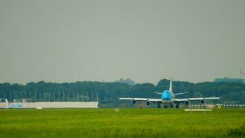 Long shot of a jumbo jet on the runway starts accelerating for takeoff. Unrecognizable airliner on the airfield, front view video