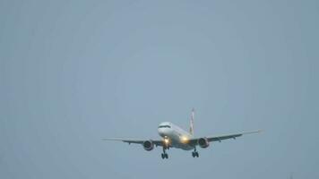 PHUKET, THAILAND NOVEMBER 28, 2019 - Front view of Boeing 757 of Sunday Airlines landing at Phuket Airport. Airliner arrival, flies past trees. Tourism and travel concept video