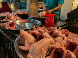 Raw chicken meat in the butcher shop. Broiler seller in traditional market. Selective focus photo