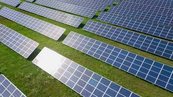 Flight over a field of solar panels in sunny summer day. Ecological innovation. video