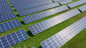 Flight over a field of solar panels in sunny summer day. Ecological innovation. video