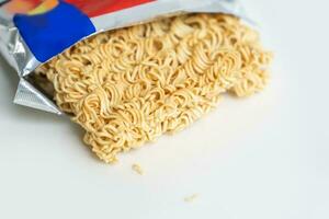 Delicious instant noodles in a bag on white background photo