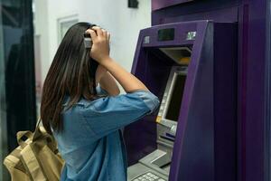 Asian woman feeling stressed She couldn't remember the ATM password. photo