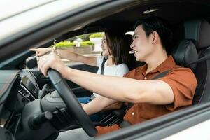 Image of young Asian couple with car photo