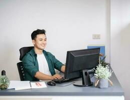 Photo of young Asian businessman working at office