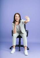 Photo of young Asian businesswoman on background