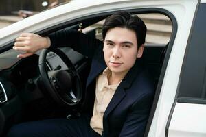 Young Asian business man with car photo