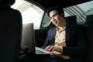 Young Asian business man with car photo