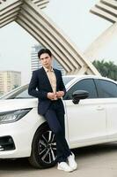 Young Asian business man with car photo