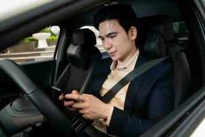 Young Asian business man with car photo