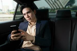 Young Asian business man with car photo