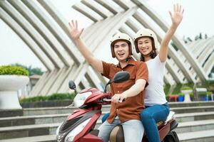 Young Asian couple on the motorbike photo