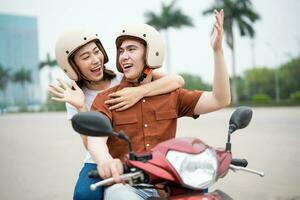 Young Asian couple on the motorbike photo