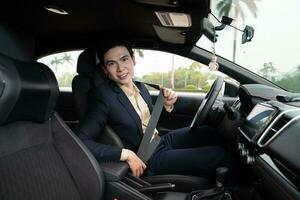 Young Asian business man with car photo