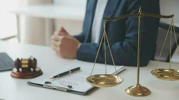 Judge gavel with Justice lawyers having team meeting at law firm in background. Concepts of law. video