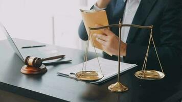 Justice and law concept.Male judge in a courtroom with the gavel, working with, computer and docking keyboard, eyeglasses, on table in morning light video