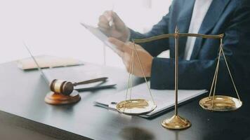 Justice and law concept.Male judge in a courtroom with the gavel, working with, computer and docking keyboard, eyeglasses, on table in morning light video