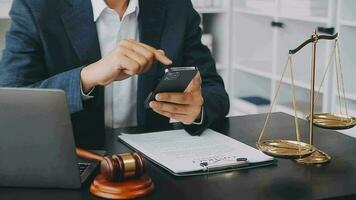 Justice and law concept.Male judge in a courtroom with the gavel, working with, computer and docking keyboard, eyeglasses, on table in morning light video