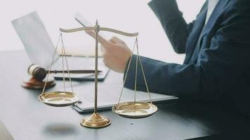 Justice and law concept.Male judge in a courtroom with the gavel, working with, computer and docking keyboard, eyeglasses, on table in morning light video