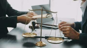 Justice and law concept.Male judge in a courtroom with the gavel, working with, computer and docking keyboard, eyeglasses, on table in morning light video