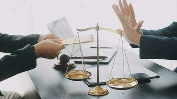 Justice and law concept.Male judge in a courtroom with the gavel, working with, computer and docking keyboard, eyeglasses, on table in morning light video