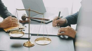 Justice and law concept.Male judge in a courtroom with the gavel, working with, computer and docking keyboard, eyeglasses, on table in morning light video