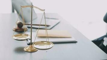Justice and law concept.Male judge in a courtroom with the gavel, working with, computer and docking keyboard, eyeglasses, on table in morning light video