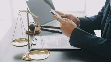 Justice and law concept.Male judge in a courtroom with the gavel, working with, computer and docking keyboard, eyeglasses, on table in morning light video