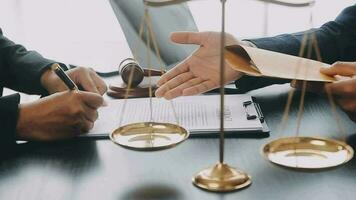 Justice and law concept.Male judge in a courtroom with the gavel, working with, computer and docking keyboard, eyeglasses, on table in morning light video