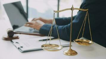 Justice and law concept.Male judge in a courtroom with the gavel, working with, computer and docking keyboard, eyeglasses, on table in morning light video
