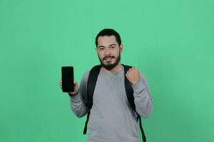 bearded asian student expression using smartphone photo