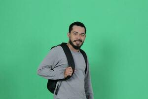 bearded asian student expression using backpack photo