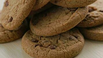 round chip cake cookies with chocolate on white surface slow rotating video