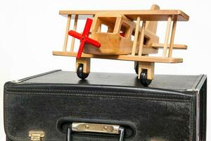 Travel concept. Retro style suitcase and biplane on white background photo