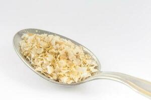 Spoonful of quinoa flakes. Chenopodium quinoa photo