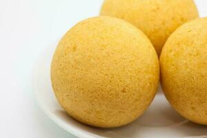 Traditional Colombian bunuelos isolated on white background. Deep Fried Cheese Bread photo