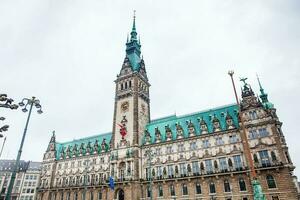 Hamburg City Hall buildiing located in the Altstadt quarter in the city center at the Rathausmarkt square in a cold rainy early spring day photo