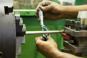 Man measuring a rod diameter photo