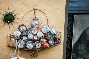 Antique alarm clocks in a metal basket photo