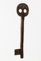 Antique rusty key isolated on white background photo