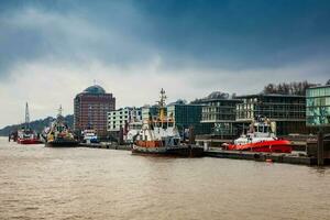 Tugboats docked at the Hamburg port on the banks of the Elbe river photo