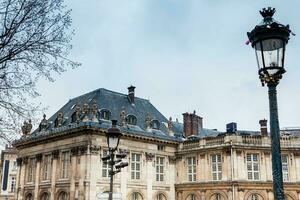 Street lamp with love locks next to the Institute of France in Paris photo