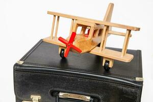 Travel concept. Retro style suitcase and biplane on white background photo