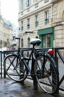 Bicycle covered with snow in a freezing winter day in Paris France photo