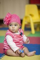 Sweet little baby girl learning to play instruments. photo