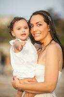 Mother and her baby girl looking at the camera photo